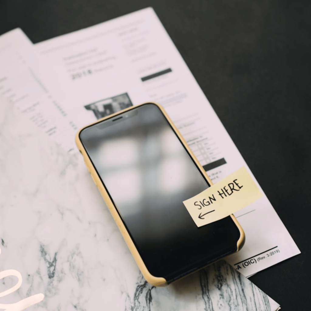 A person filling out a Verification of Identity Form (VIF) in Ireland, with supporting documents like a passport and driver's license.
