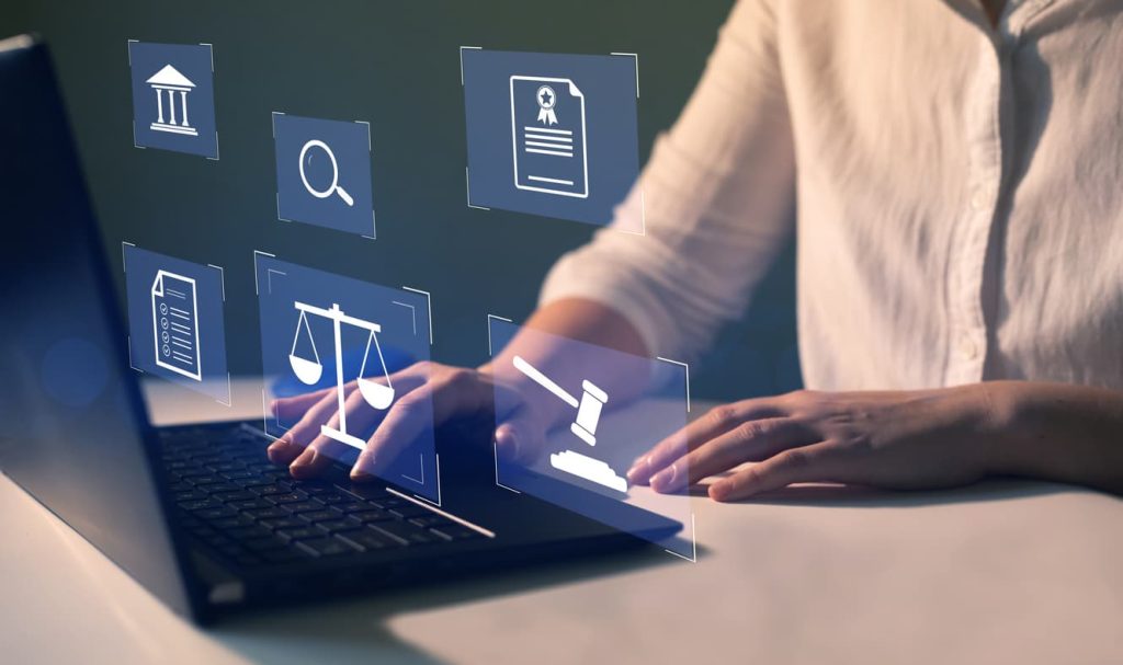 Person using laptop with virtual legal icons representing digital notary services and online document authentication in 2025 by NotaryPublic24.com.